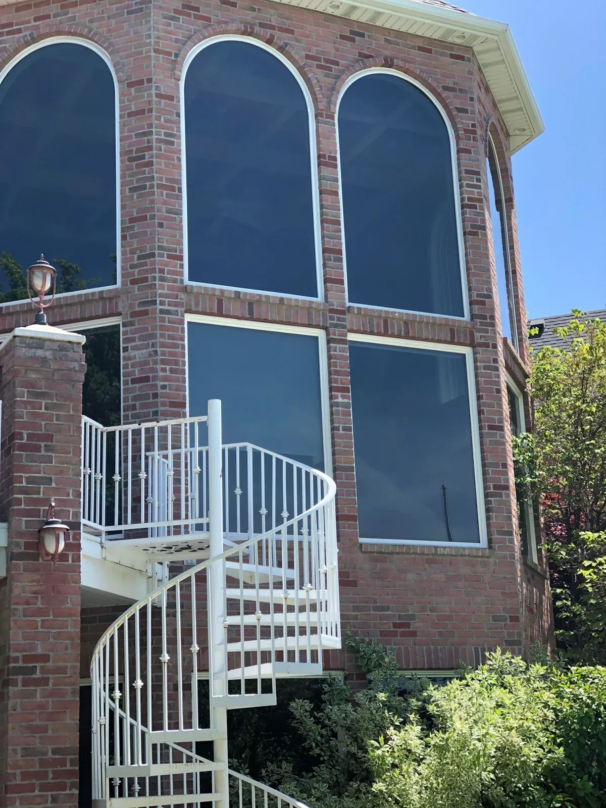 Windows and entry doors on a white two-story home