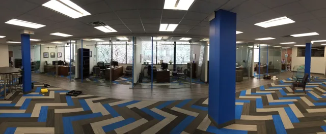 Interior office with glass partitions and blue accents