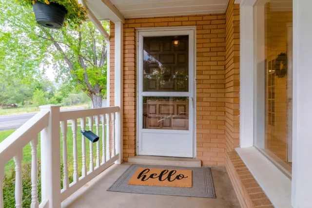 A storm door at a brick home’s front entrance